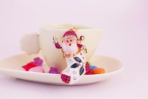 Close-up of Santa Claus in a sparkling Christmas stocking charm with pink rhinestones