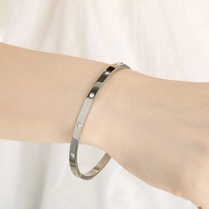 Macro detail of silver titanium steel bracelet with pavé-set shimmering zircon stones
