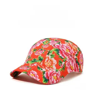 Detail of red floral newsboy cap featuring colorful peony prints and breathable fabric