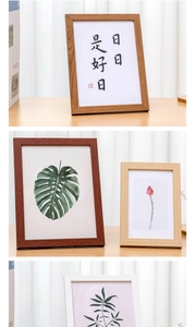 Detailed view of wooden photo frames with assorted colors and artistic botanical prints