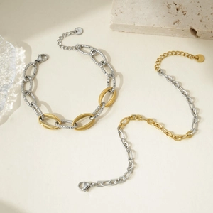 Two-tone interlocking stainless steel chain bracelet with gold oval rings and steel beads