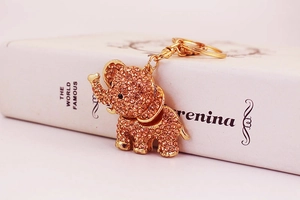Close-up of a golden elephant keychain featuring sparkling rhinestones and metal details