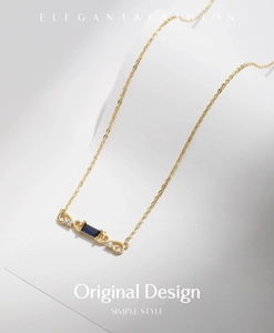 Macro detail of S925 silver necklace with deep blue sapphire stone and vine design