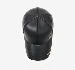 Top view of black leather baseball cap with gold lettering and metal badge detail