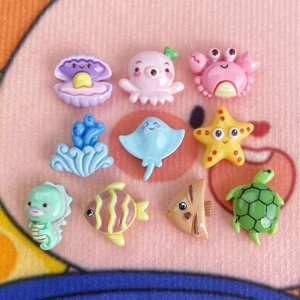 Close-up of 10 mini colorful resin ocean animal charms for DIY crafts and hair accessories