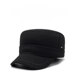 Detail of black wool flat top hat with metal logo and warm ear protection flaps