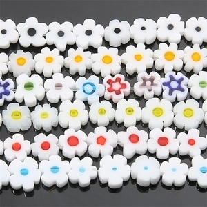Macro shot of colorful flat plum blossom glass beads for DIY jewelry making accessories