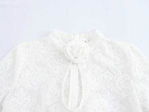 Detail of white lace stand collar top with 3D rose decoration and front zipper closure