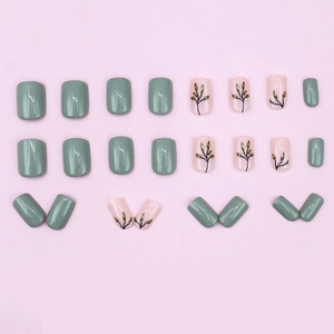 Short square press-on nails in matcha green and pale pink with delicate leaf designs