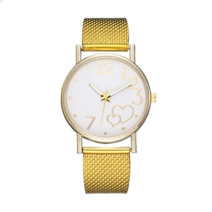 Detailed macro view of the heart-patterned dial and golden mesh band on this ladies watch