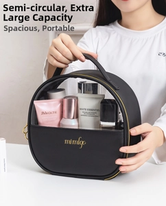 Detail of crescent travel cosmetic bag with PVC window and golden mimlogo branding