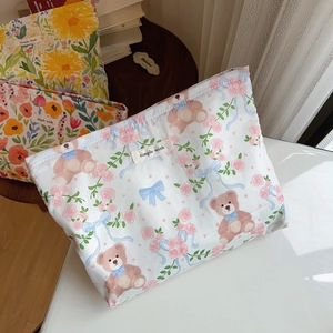 Detail of floral makeup bag featuring a Simple Wish label on a high-quality cotton fabric