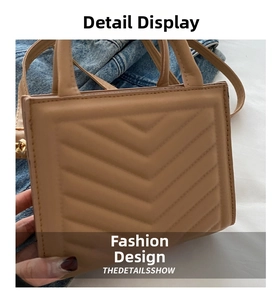 Detailed view of beige faux leather handbag with premium V-shaped quilted stitching
