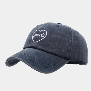 Close-up of vintage washed gray cotton baseball cap with heart Paris embroidery detail