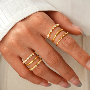 Detailed macro view of 18K gold plated ring set featuring zircon inlay and layered styling