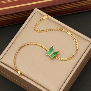 Elegant gold-plated snake chain necklace featuring a green butterfly pendant on a jewelry box