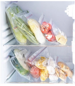 Detail of clear food storage bags with labels and zipper seal inside a refrigerator