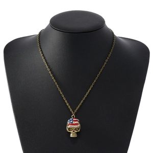 Detail of bronze skull pendant with American flag pattern made of colorful rhinestones