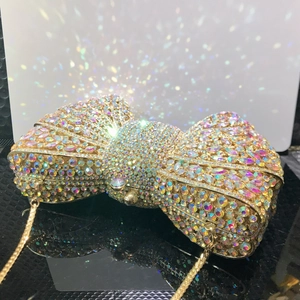 Luxury bow-shaped evening clutch bag with iridescent rhinestones and gold chain strap