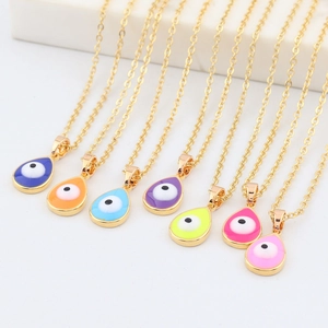 Close-up of colorful evil eye waterdrop pendants with gold finish on a display stand