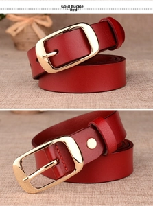 Detailed close-up of a red leather belt with a polished gold single-prong metal buckle