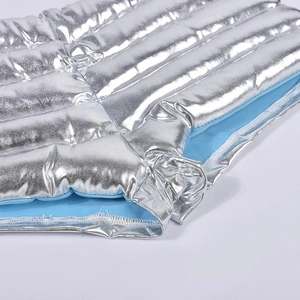 Detail of silver metallic quilted fabric with water-resistant finish and light blue lining