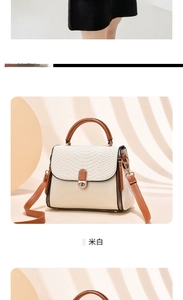 Close-up of off-white crossbody bag featuring snake pattern texture and gold turn-lock