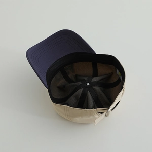 Detail view of cotton baseball cap interior with sweatband and adjustable metal buckle