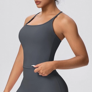 Detail of dark grey yoga top with slim straps and high-waist matte fitness leggings