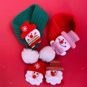 Detailed view of red and green knitted Christmas cat collars with snowman accents
