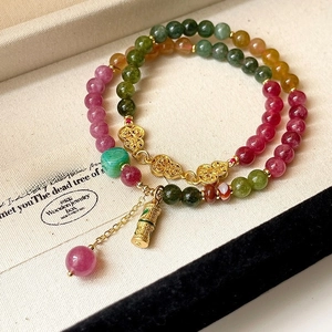 Close-up of multi-color crystal beads with gold Ruyi lock charms in Chinese style