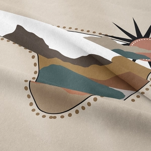 Detail of soft fabric texture with abstract mountain and sun prints in earth tones