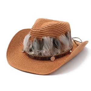 Detail of woven straw cowboy hat with natural feathers and ethnic coin charms