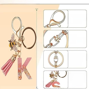 Pink glitter resin letter keychain with metal bee charm and tassel accessory
