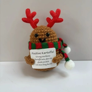Handmade crochet positive potato with reindeer antlers and festive scarf holding a card
