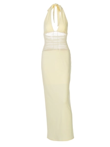 Detail view of yellow halter dress featuring sheer mesh patchwork and a deep V-neckline