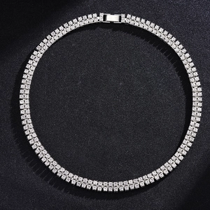 Detailed view of silver double row tennis chain with sparkling rhinestones on black background