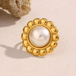 Detailed macro view of an 18K gold-plated flower ring with a large white pearl center