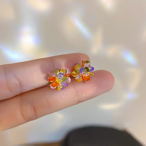 Macro shot of colorful crystal flower earrings with S925 silver pins and intricate details