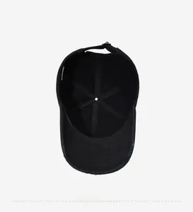 Detail view of the black cotton baseball cap interior stitching and adjustable buckle