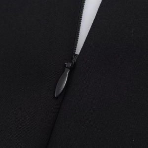 Close-up of a high-quality black invisible zipper on a premium knitted fabric jumpsuit