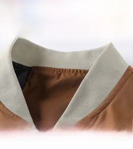 Detail view of the ribbed knit collar and double stitching on a brown casual jacket