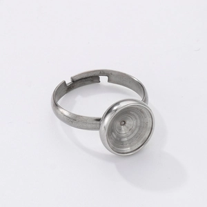 Close-up of adjustable silver stainless steel ring base with circular blank tray for DIY