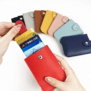 Close-up of litchi grain faux leather luggage tags with button snap and card slots