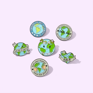 Set of 6 eco-friendly enamel pins with Earth Day slogans on a soft pink background