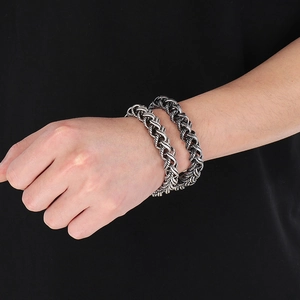 Detail of vintage silver braided stainless steel double-layer chain bracelet on wrist
