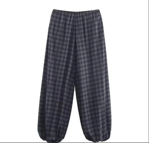 Detailed flat lay of plaid wide-leg trousers featuring elastic waist and dark check pattern