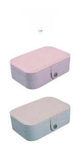 Vertical view of cross-grain leather jewelry boxes in pink and blue with snap closures