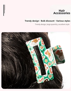 Detail of green Christmas hair claw clip with reindeer and candy cane patterns