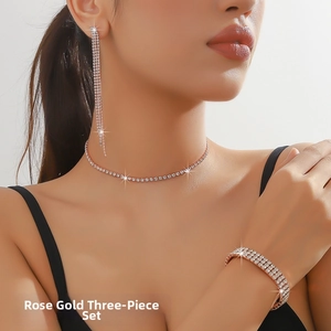 Detailed view of rose gold rhinestone jewelry set with tassel earrings and choker